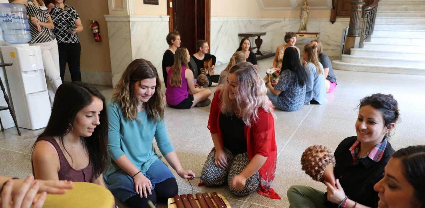 MAMT students playing instruments in the conservatory of music